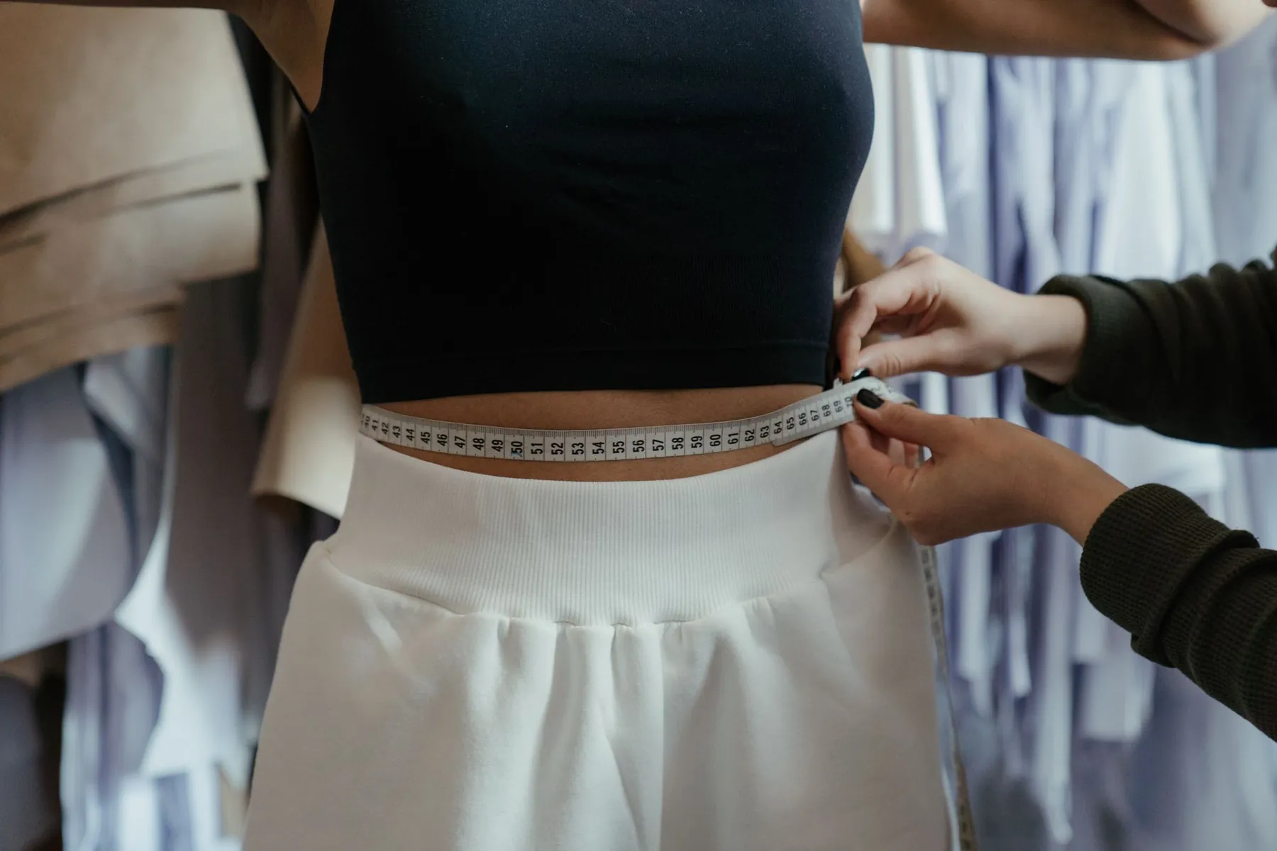 A garment being fitted, illustrating being properly measured.