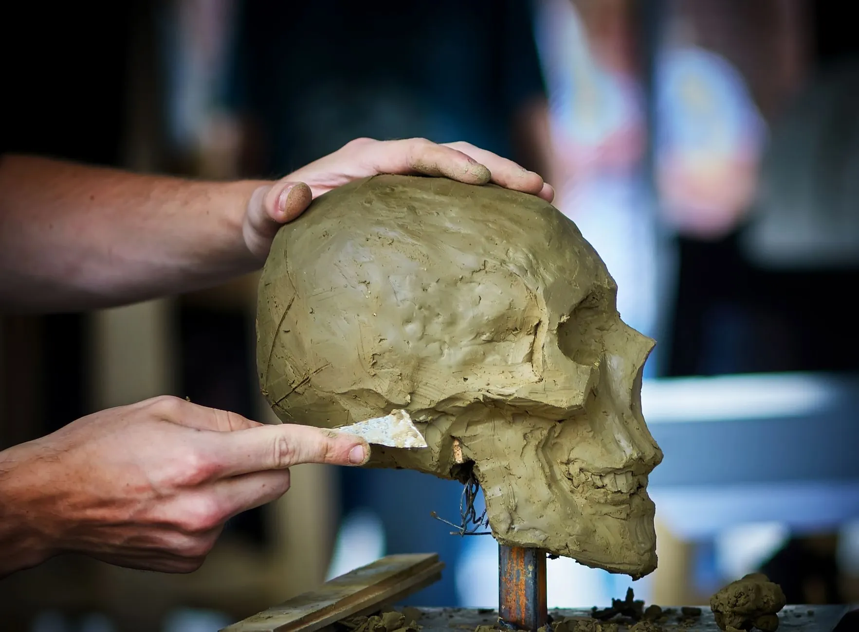 Material being added to a sculpture, illustrating that filler only adds volume.