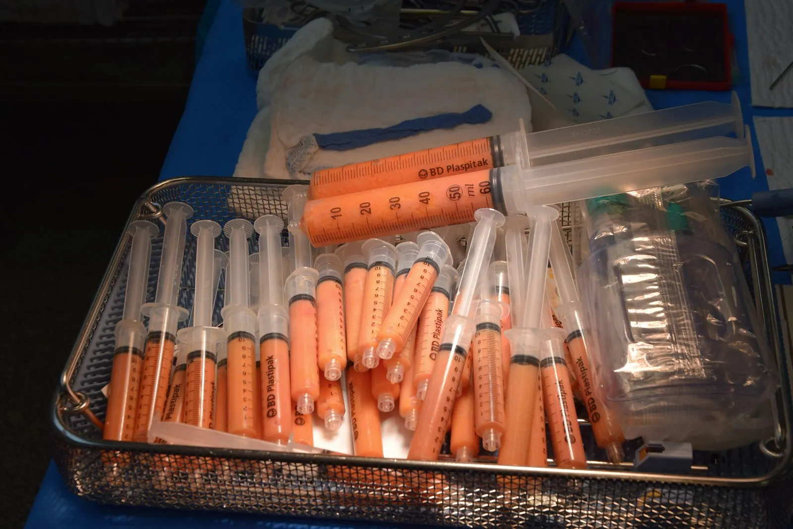 A syringe on a clinical tray, illustrating injections used around the brow.