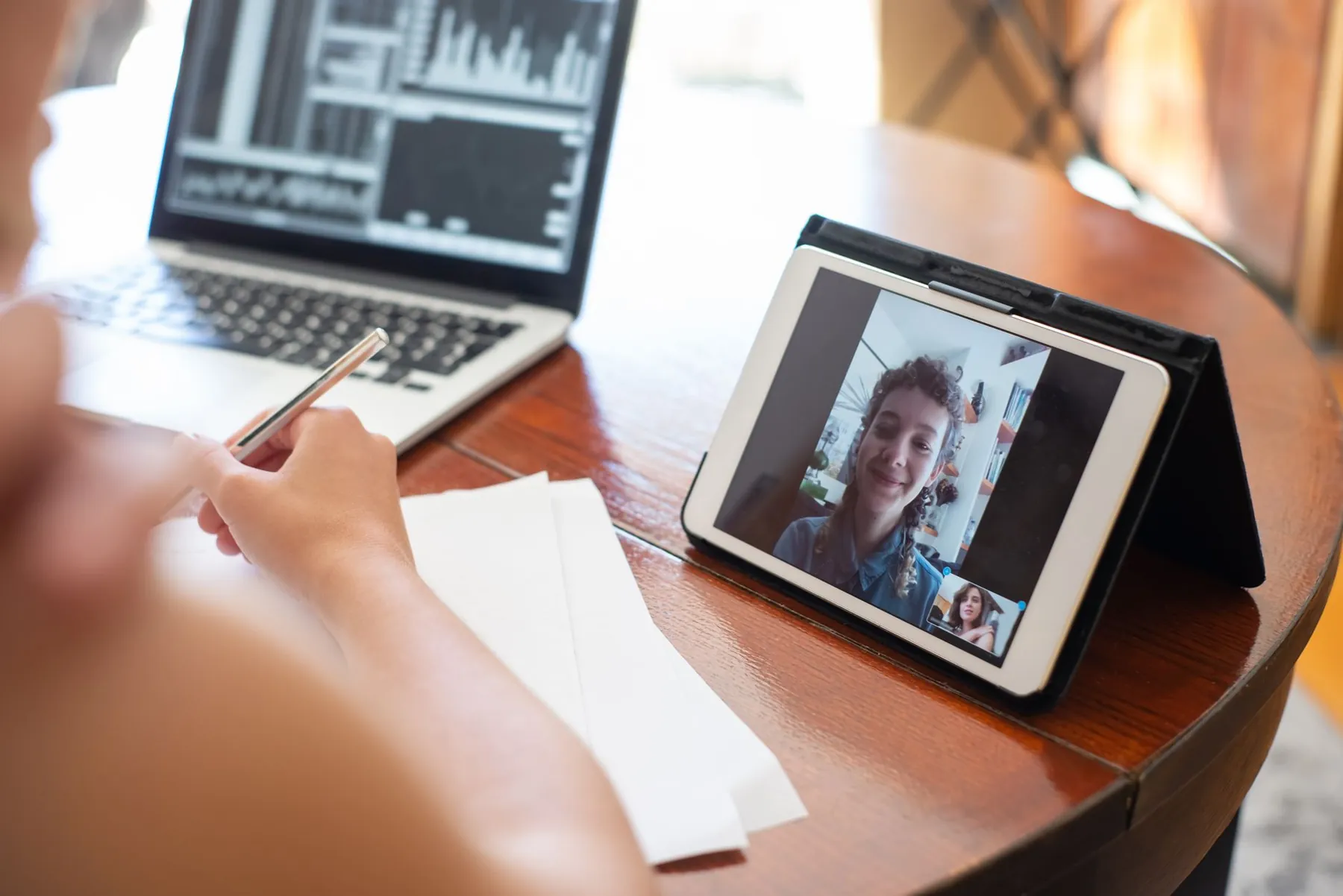 A tablet on a table at home, illustrating follow-up held remotely after returning.