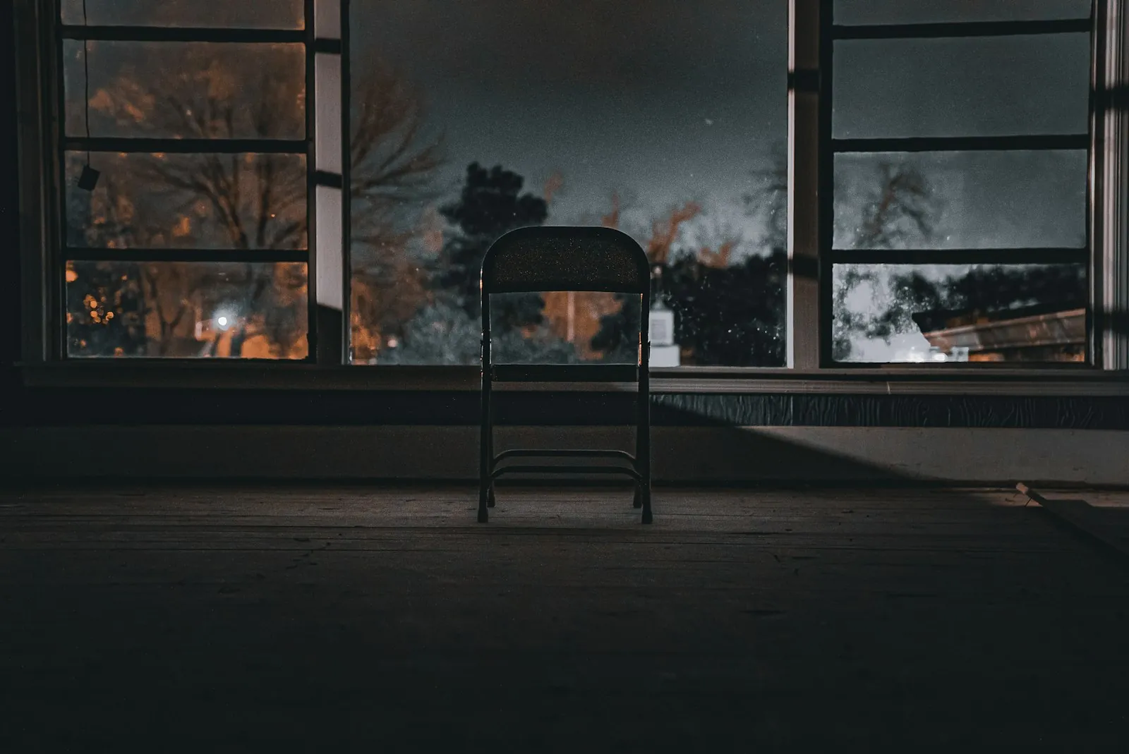 An empty chair beside a window, illustrating taking time over an elective decision.