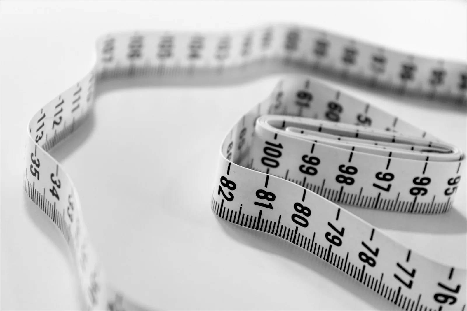 A measuring tape on a table, illustrating that dimensions rather than cup letters decide what is possible.