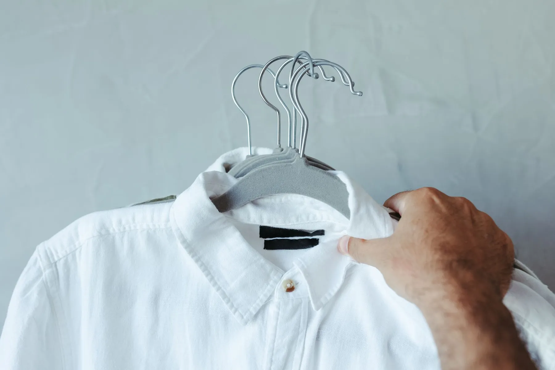A plain bra on a hanger, illustrating trying sizers in a well-fitting garment.