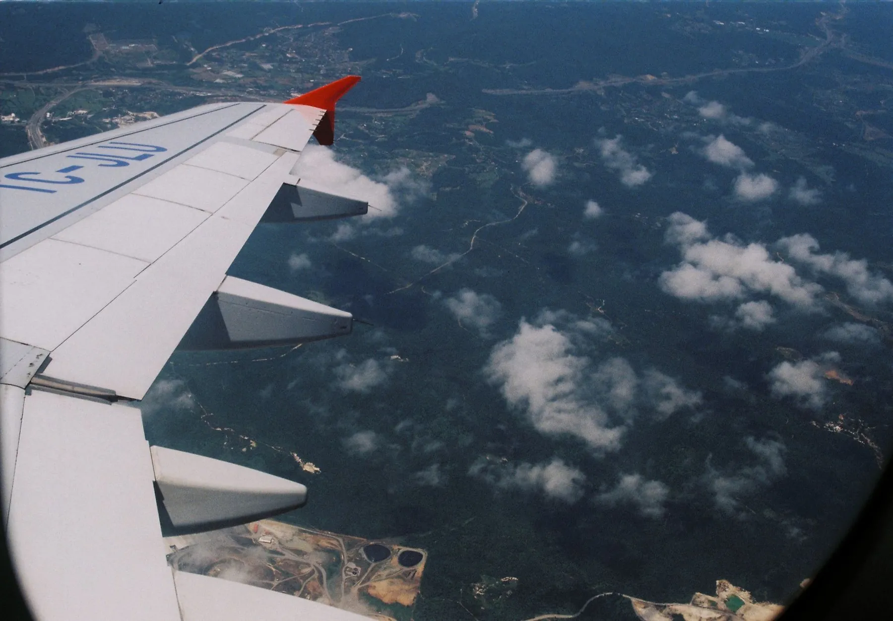 Clouds seen from an aircraft window, illustrating travelling abroad for surgery.