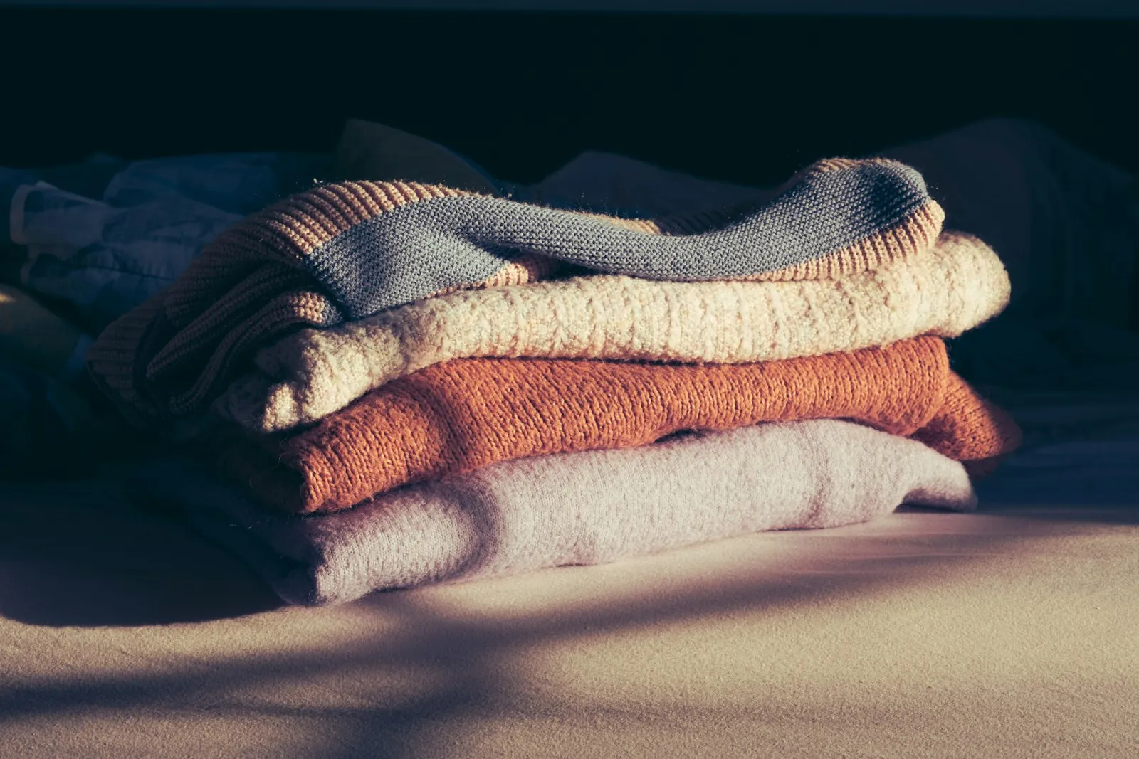 Soft front-fastening clothing folded neatly, illustrating what is easy to wear in the first week.