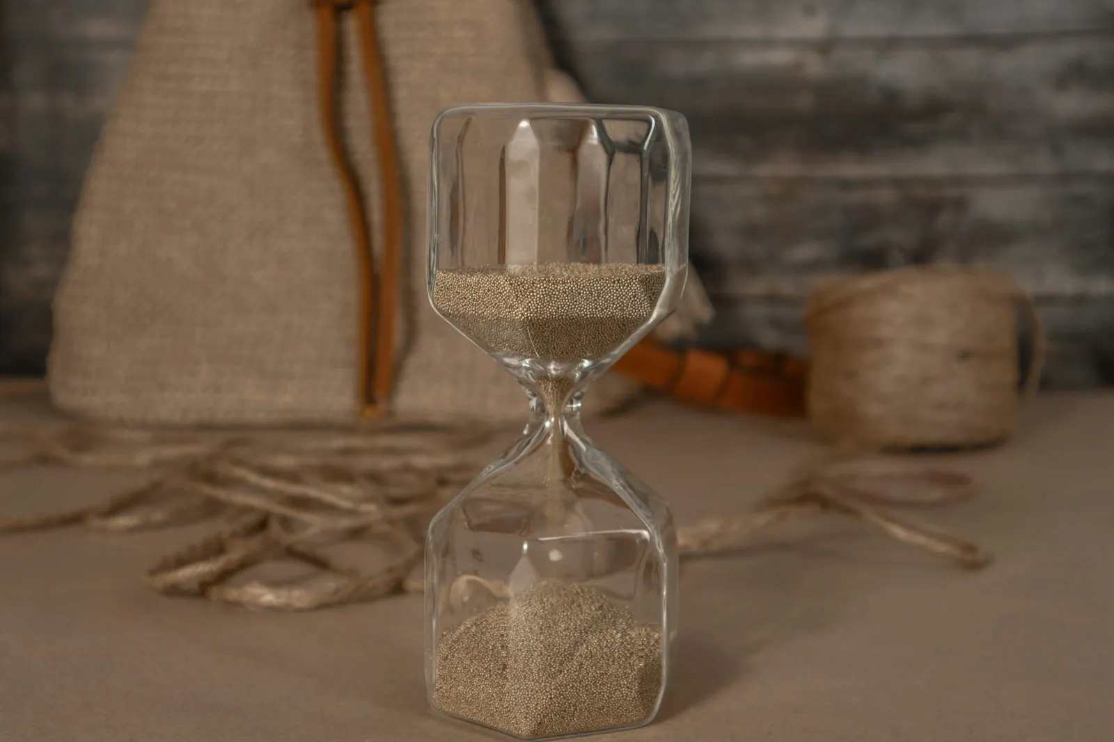An hourglass, illustrating that the settled result takes months rather than days.