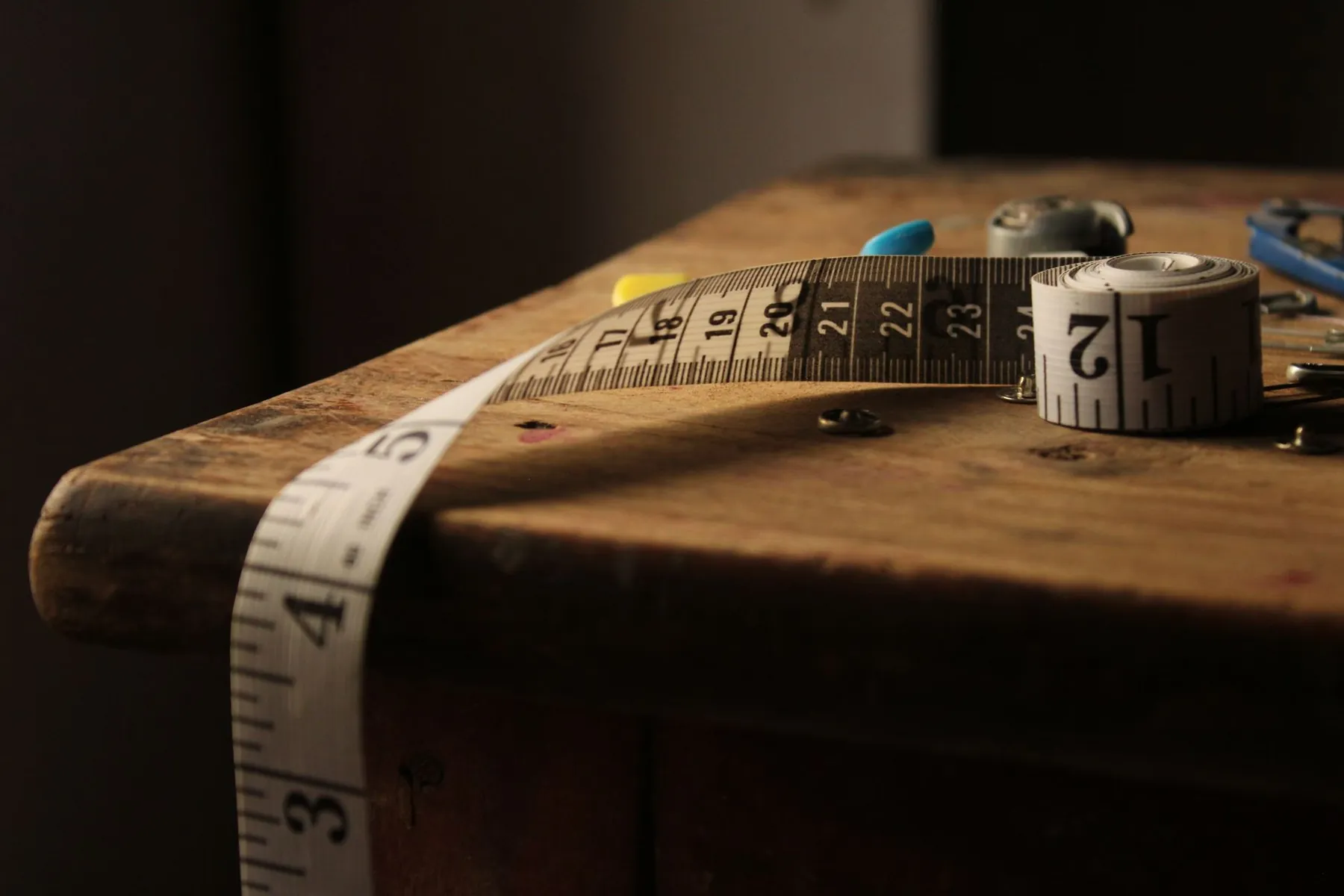 A tape measure on a workbench, illustrating assessment rather than cup size.