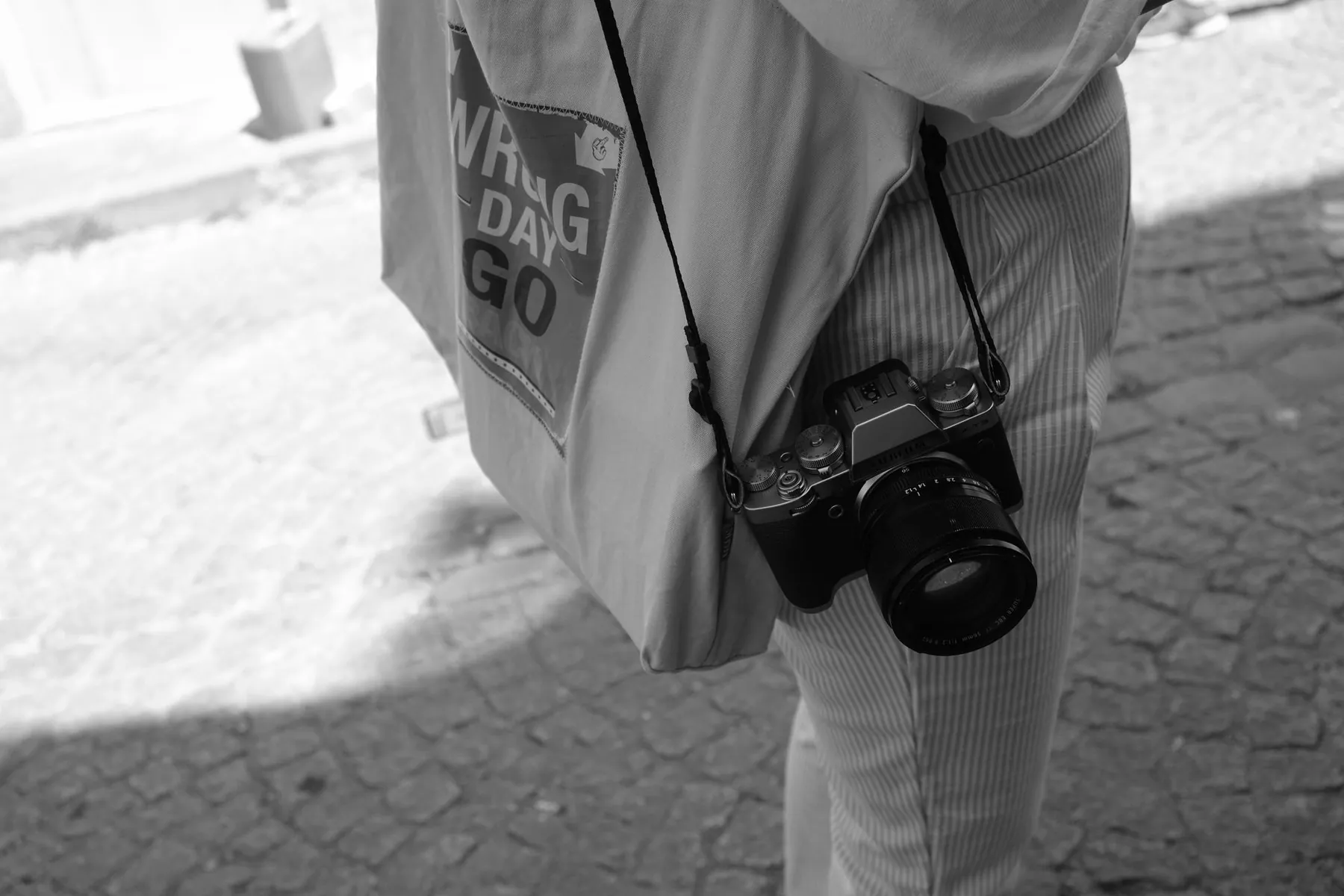 A strap pressing on a shoulder, illustrating the weight-related complaints.