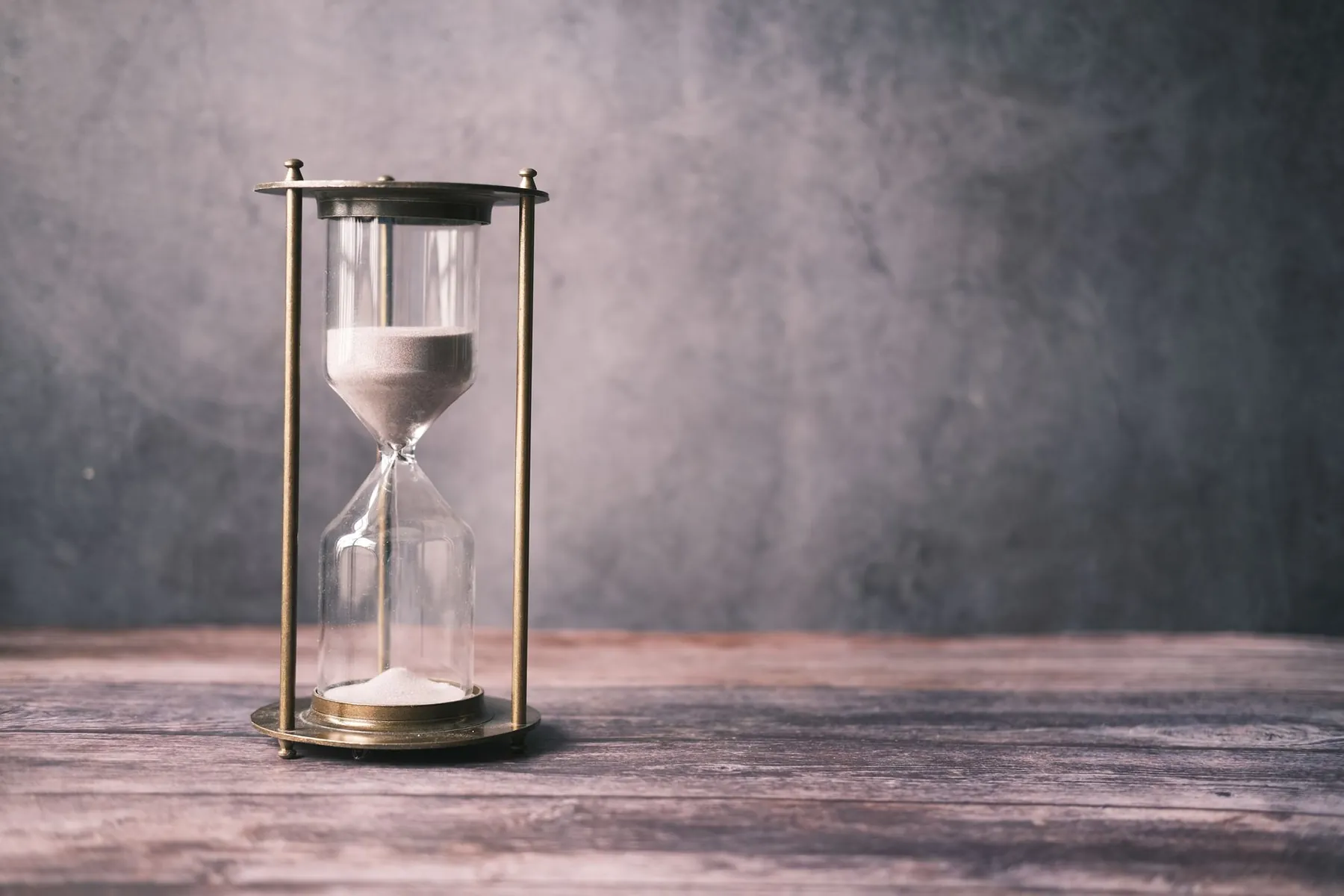 Sand running through an hourglass, illustrating waiting for the shape to settle.