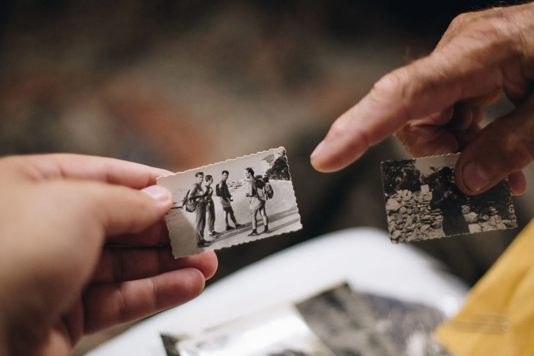 A printed photograph held up, illustrating comparing against before surgery.
