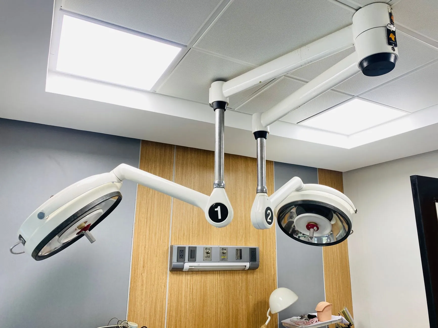 Operating theatre lights, illustrating the surgical setting.