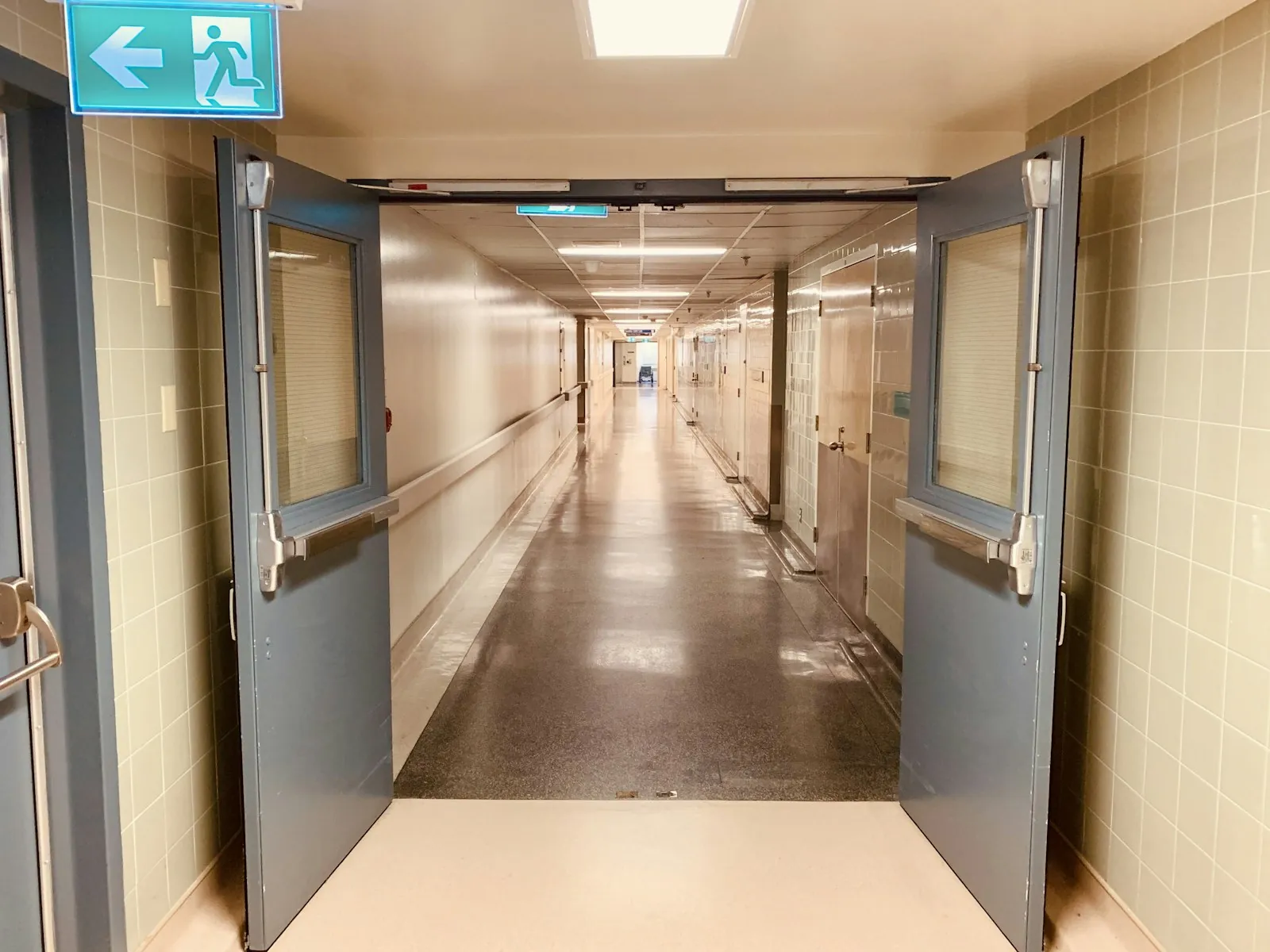 Signage in a hospital corridor, illustrating checking where treatment takes place.