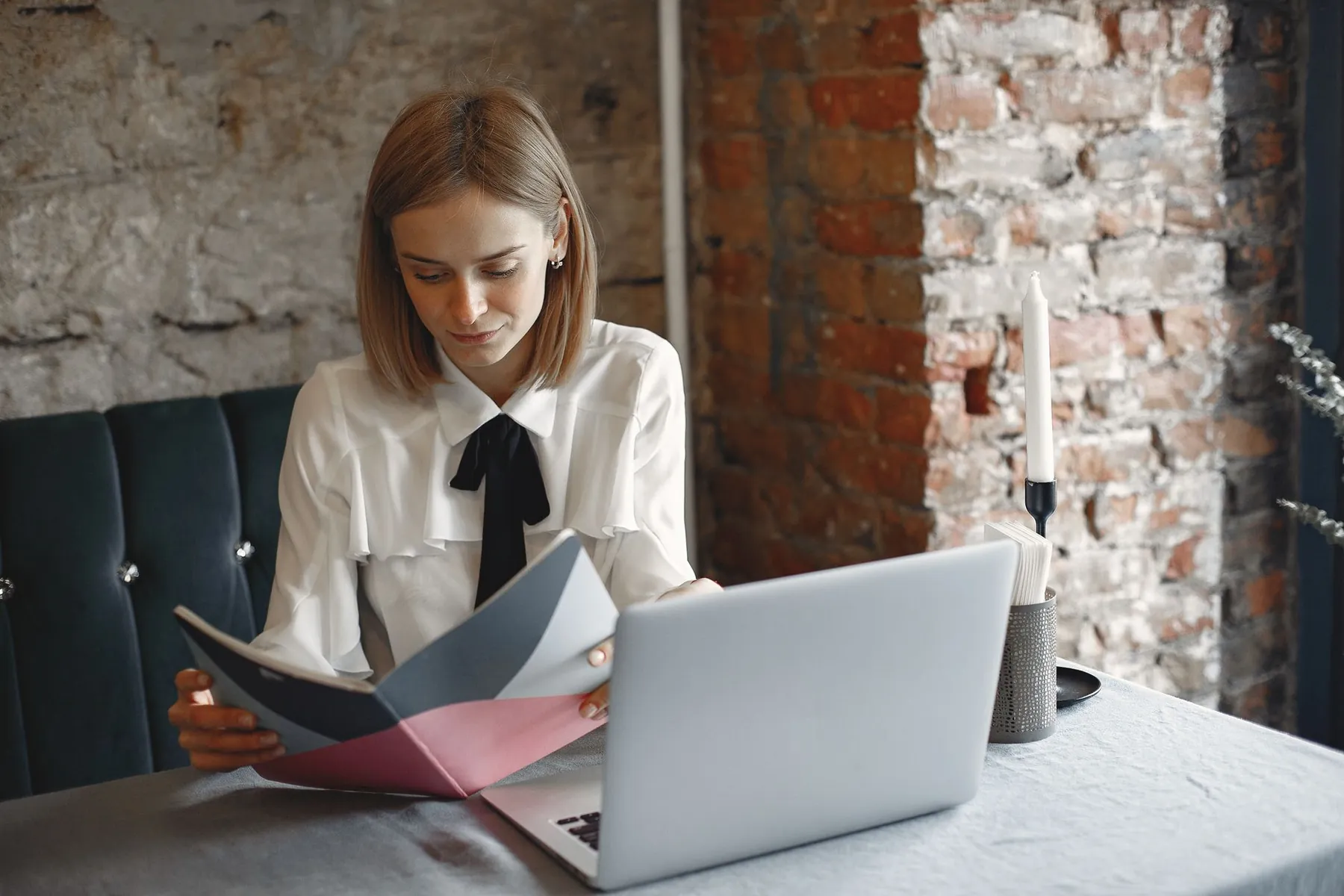 Someone reading on a laptop, illustrating weighing online reviews.