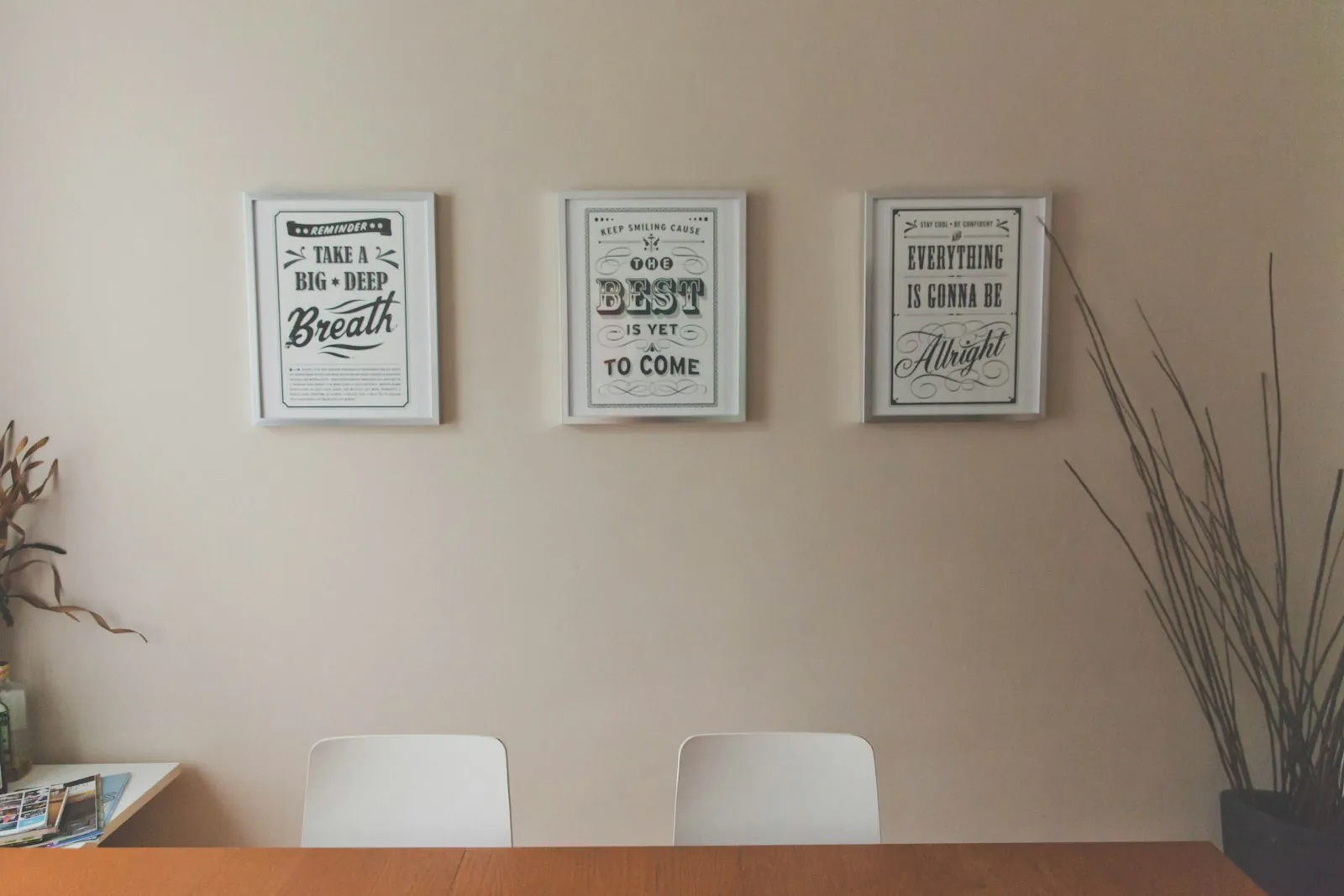 Framed certificates on an office wall, illustrating checking a surgeon's qualifications.