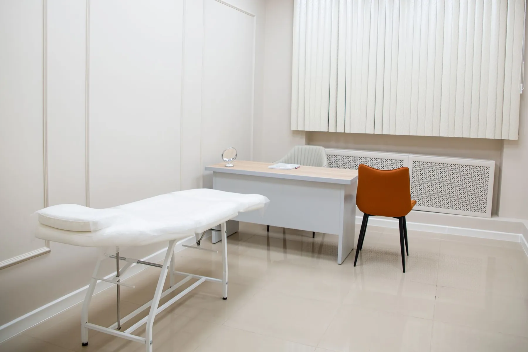 An empty consultation room with chairs and a desk, illustrating a consultation before surgery.
