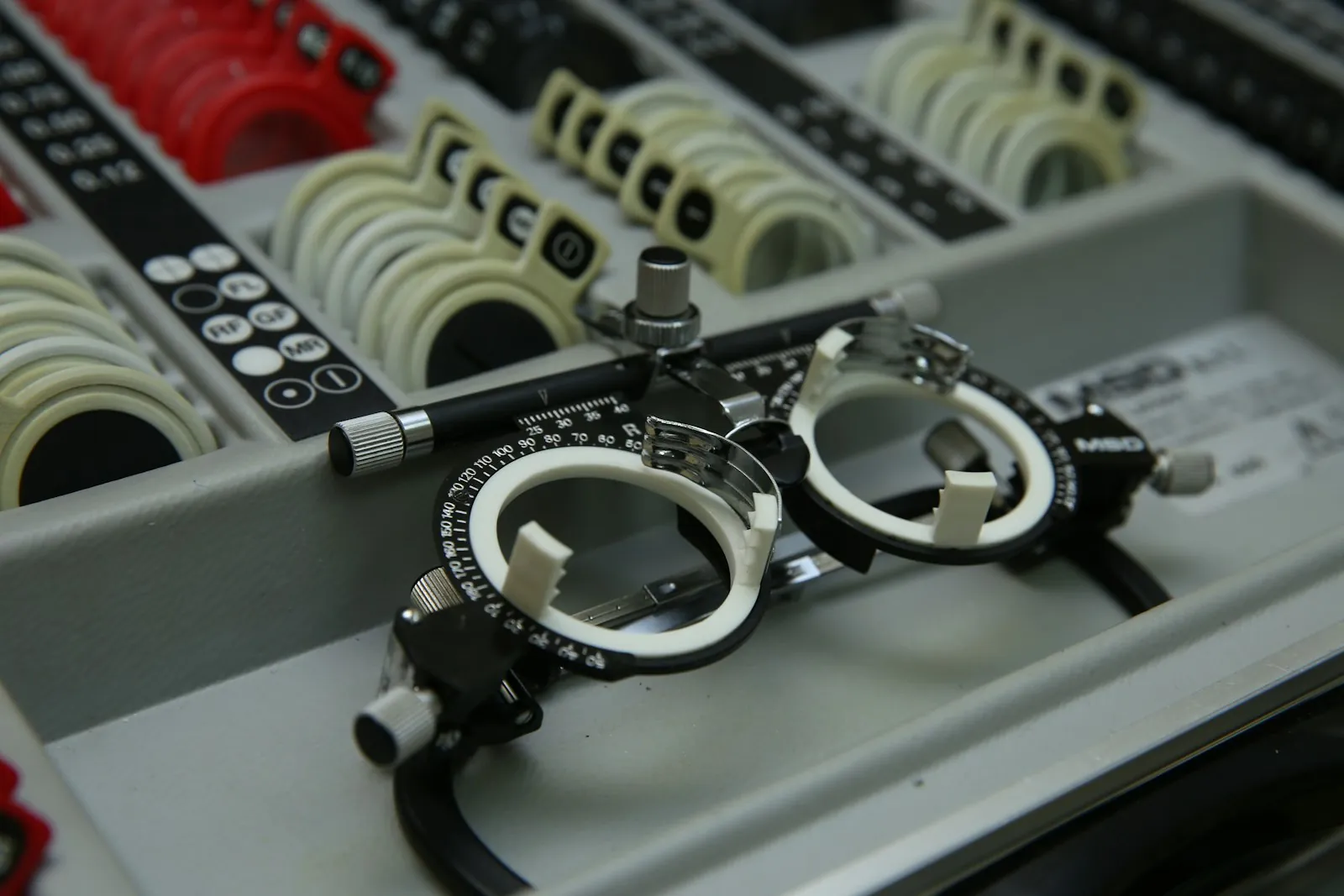Optical instruments on a desk, illustrating the specialty behind eyelid surgery.