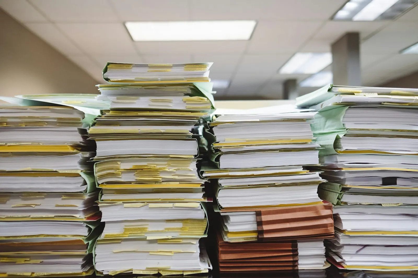 A stack of printed documents, illustrating the written record to request before flying home.