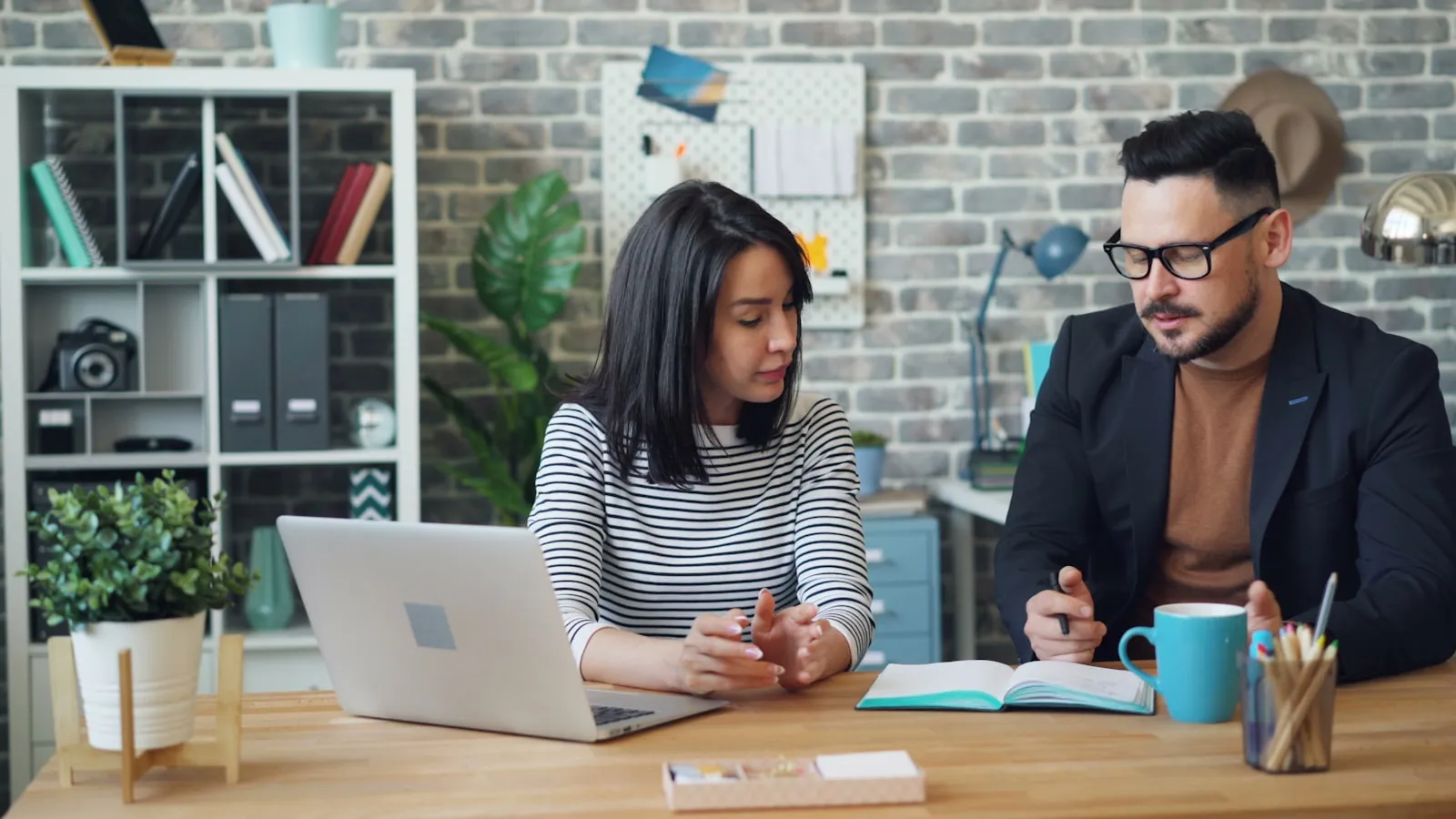 Two people talking across a desk, illustrating the consultation where suitability is decided.