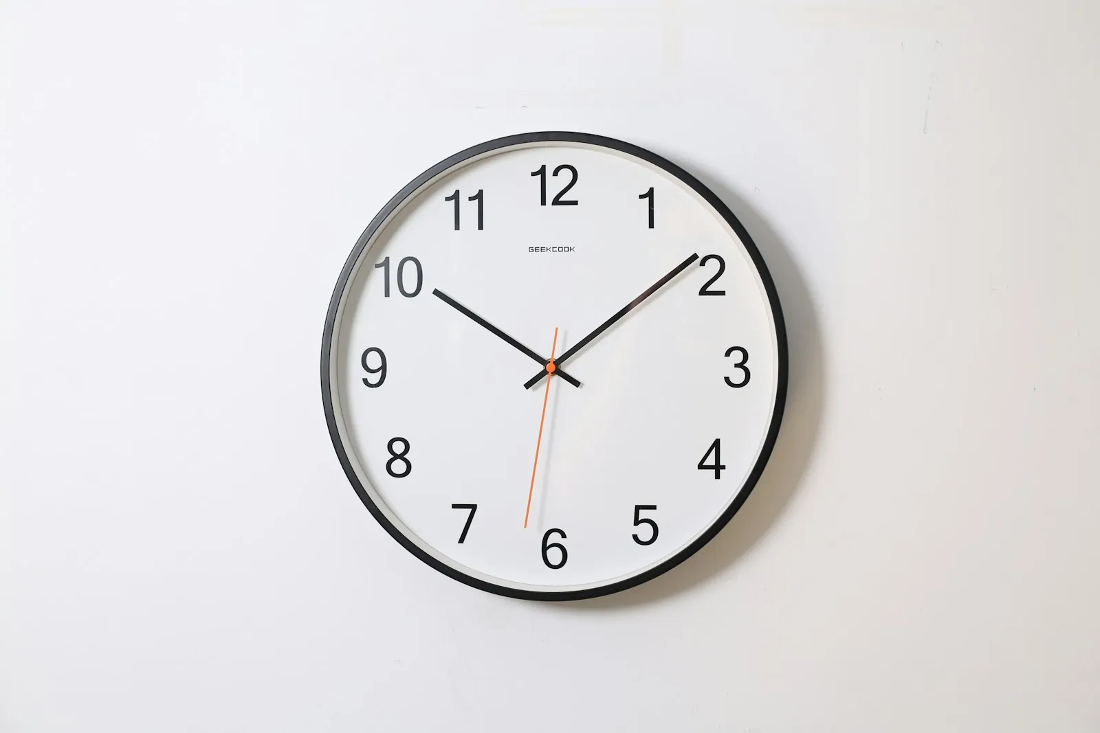 A clock on a plain wall, illustrating that scar maturation is measured in months.