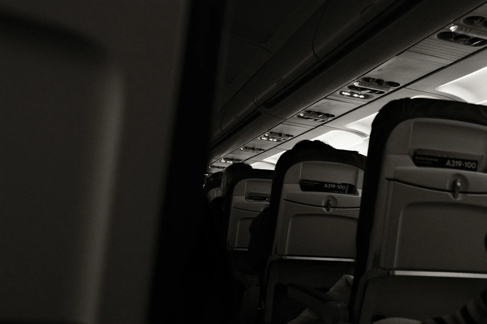 Empty aircraft seats, illustrating the hours of sitting still a flight involves.