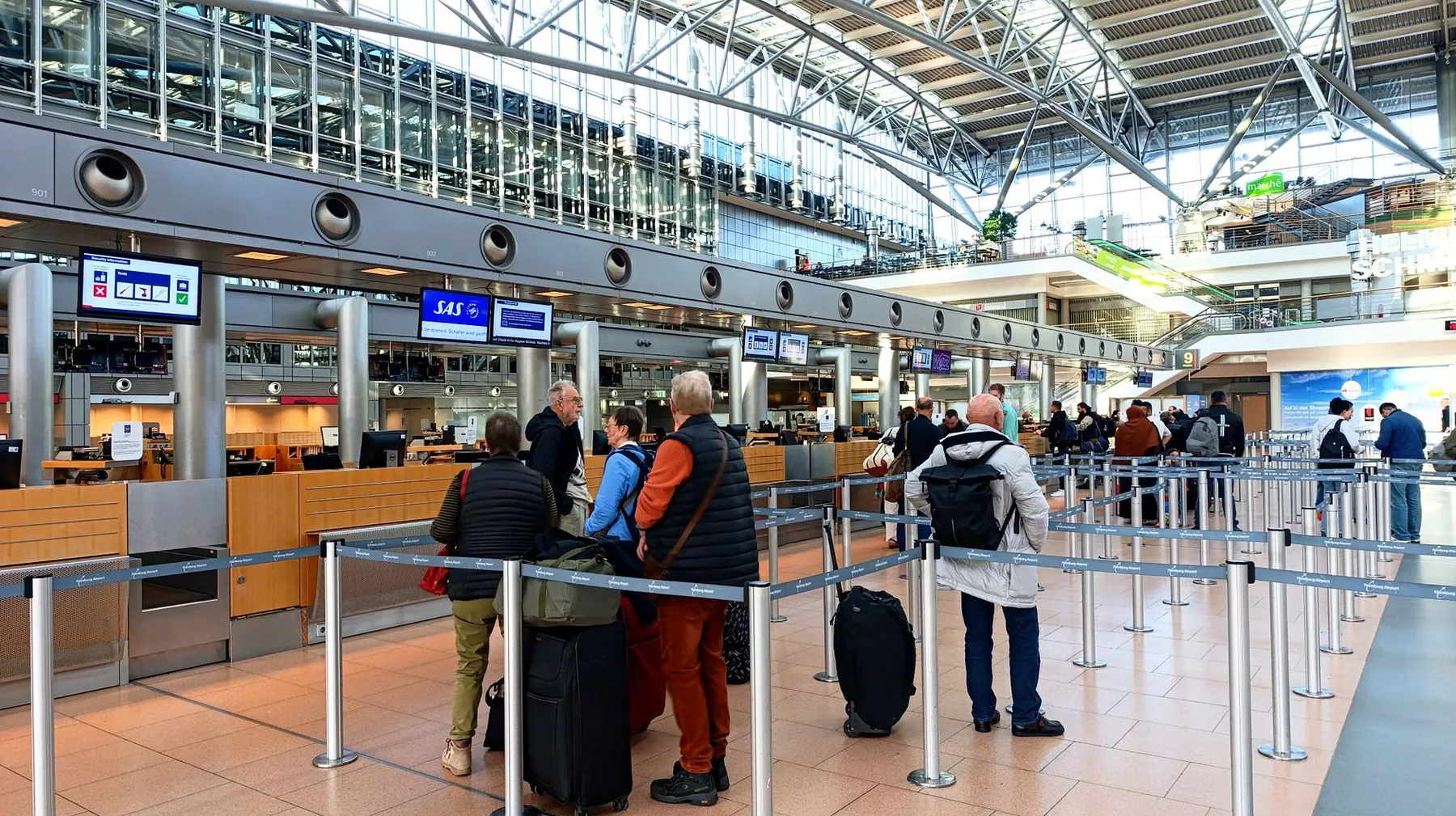 A check-in desk queue, illustrating the luggage problem after surgery.