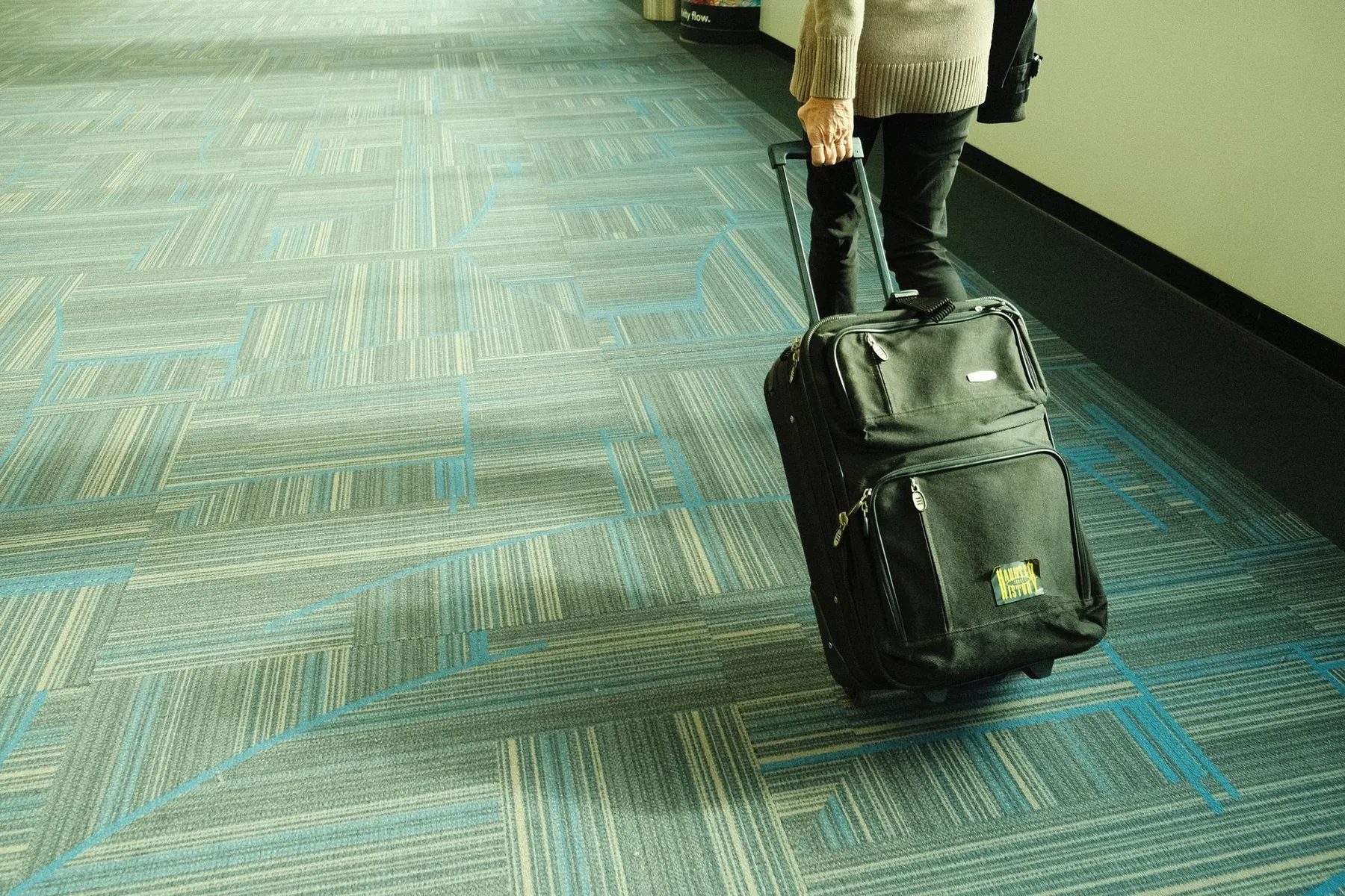 A wheeled case being pulled, illustrating luggage you do not have to lift.