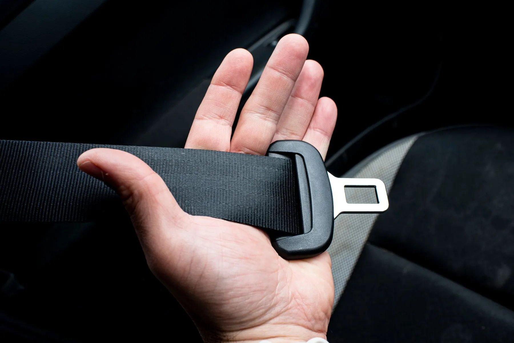 A fastened seatbelt, illustrating pressure across a healing chest.