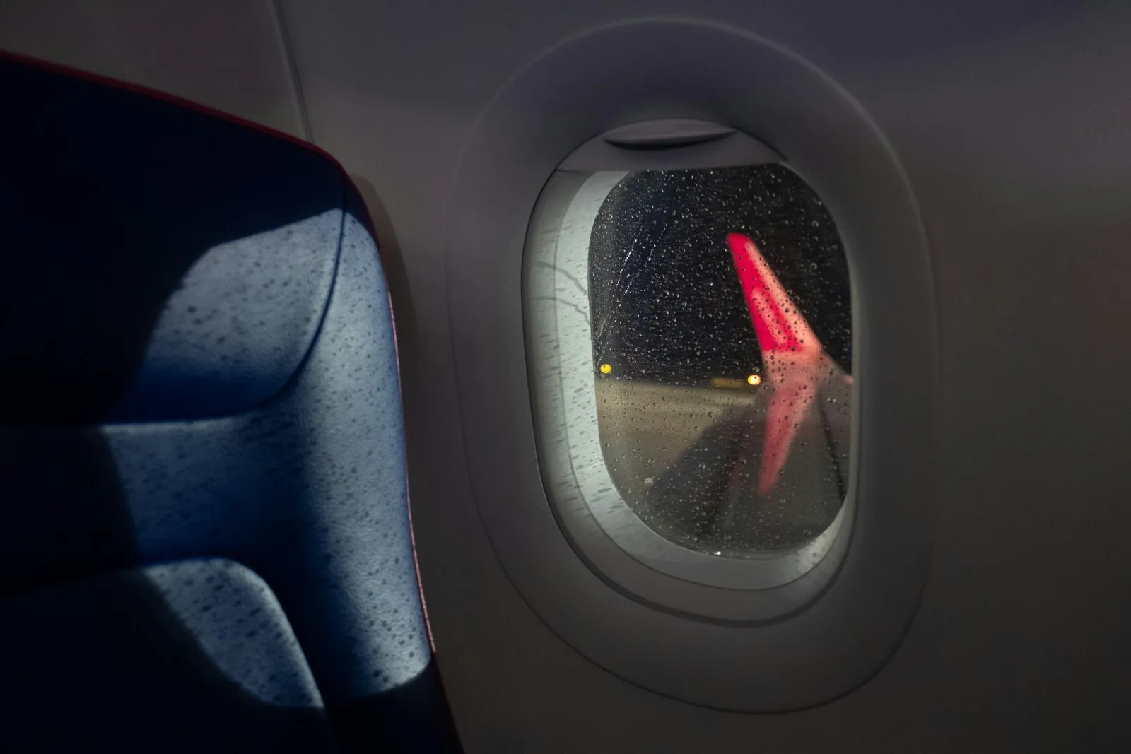 Water on a tray table, illustrating staying hydrated during a long flight.