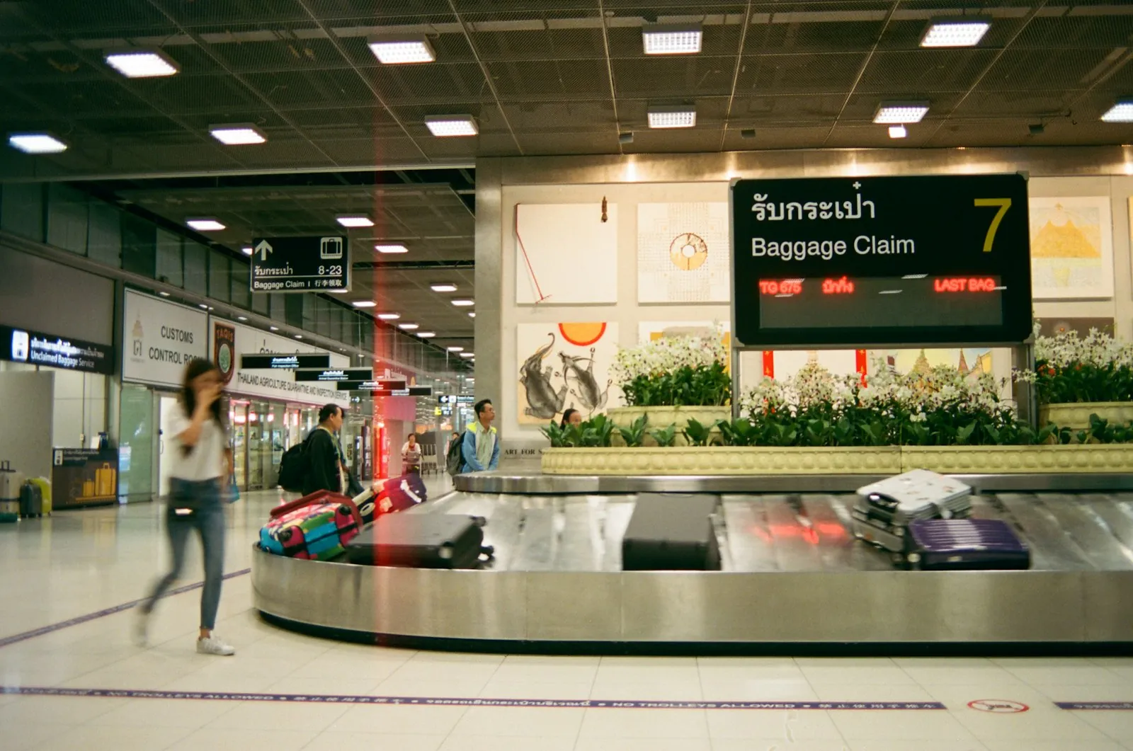 A luggage trolley at a terminal, illustrating the transfer a connecting flight adds.