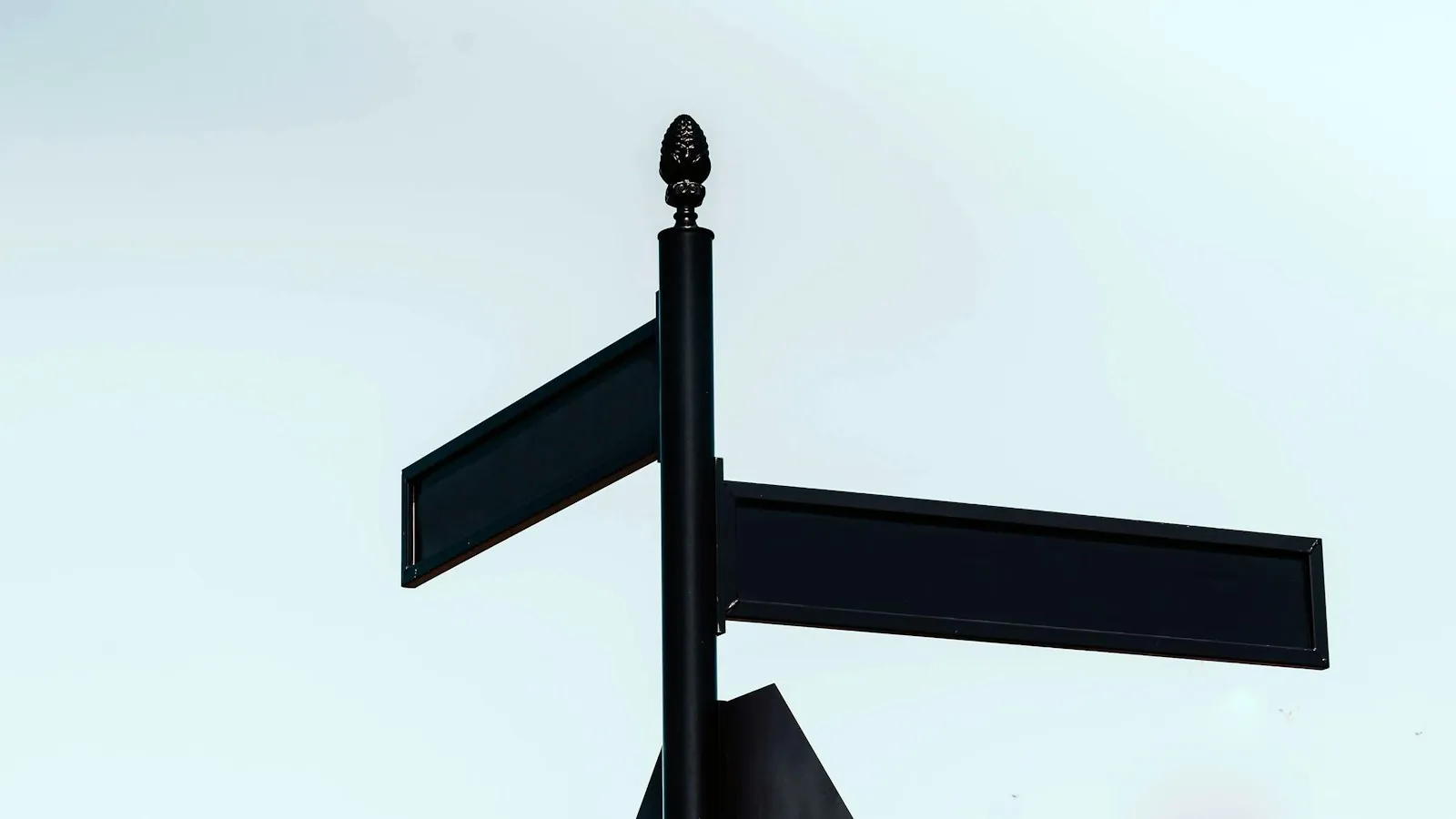A signpost pointing two ways, illustrating a choice between two clinic locations.