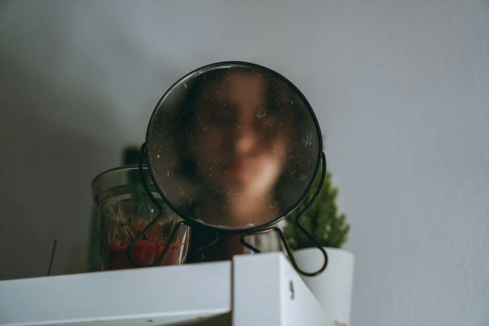 Someone checking their reflection in daylight, illustrating a routine self-check.