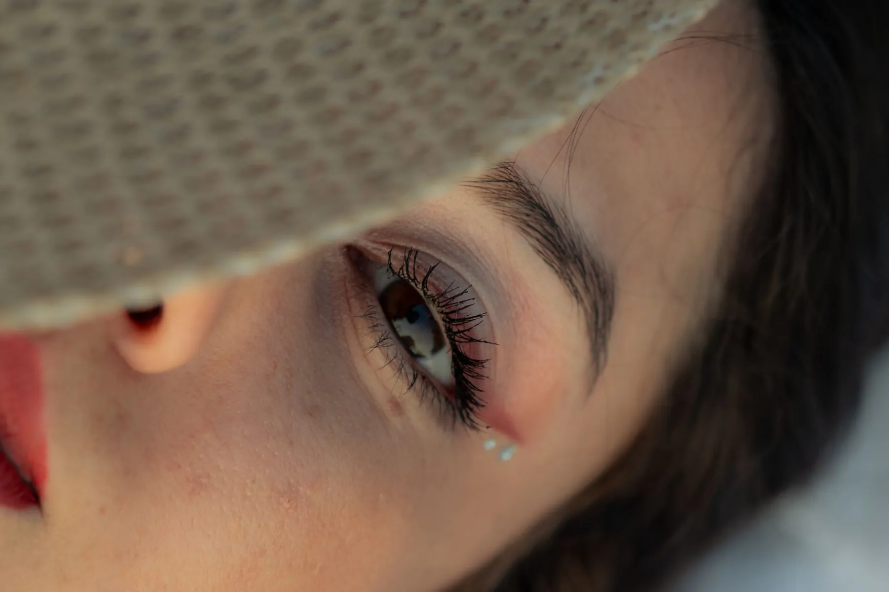 A face in soft daylight, illustrating assessing the under-eye area.