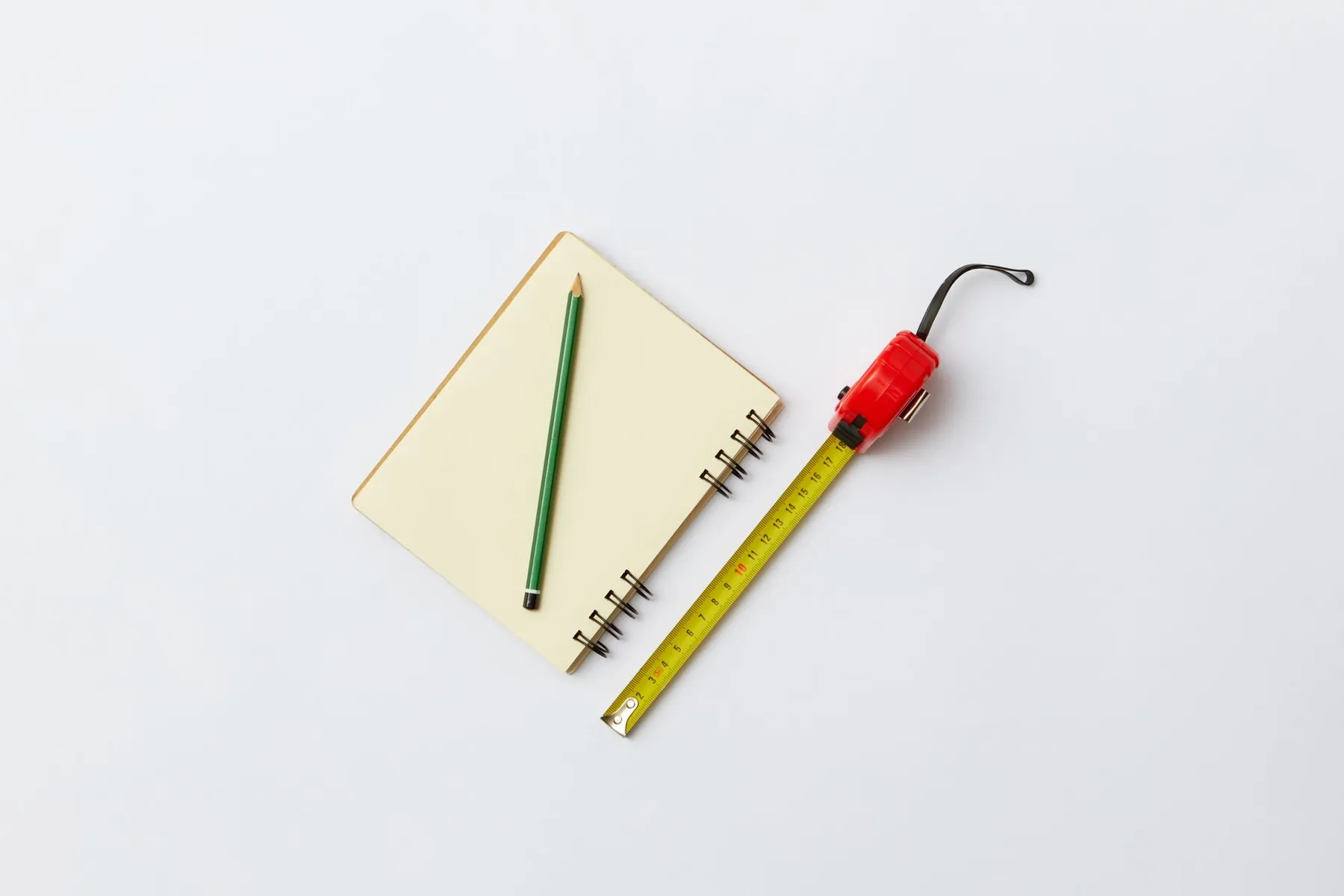 A measuring tape on a plain surface, illustrating that dimensions rather than preference set what is possible.