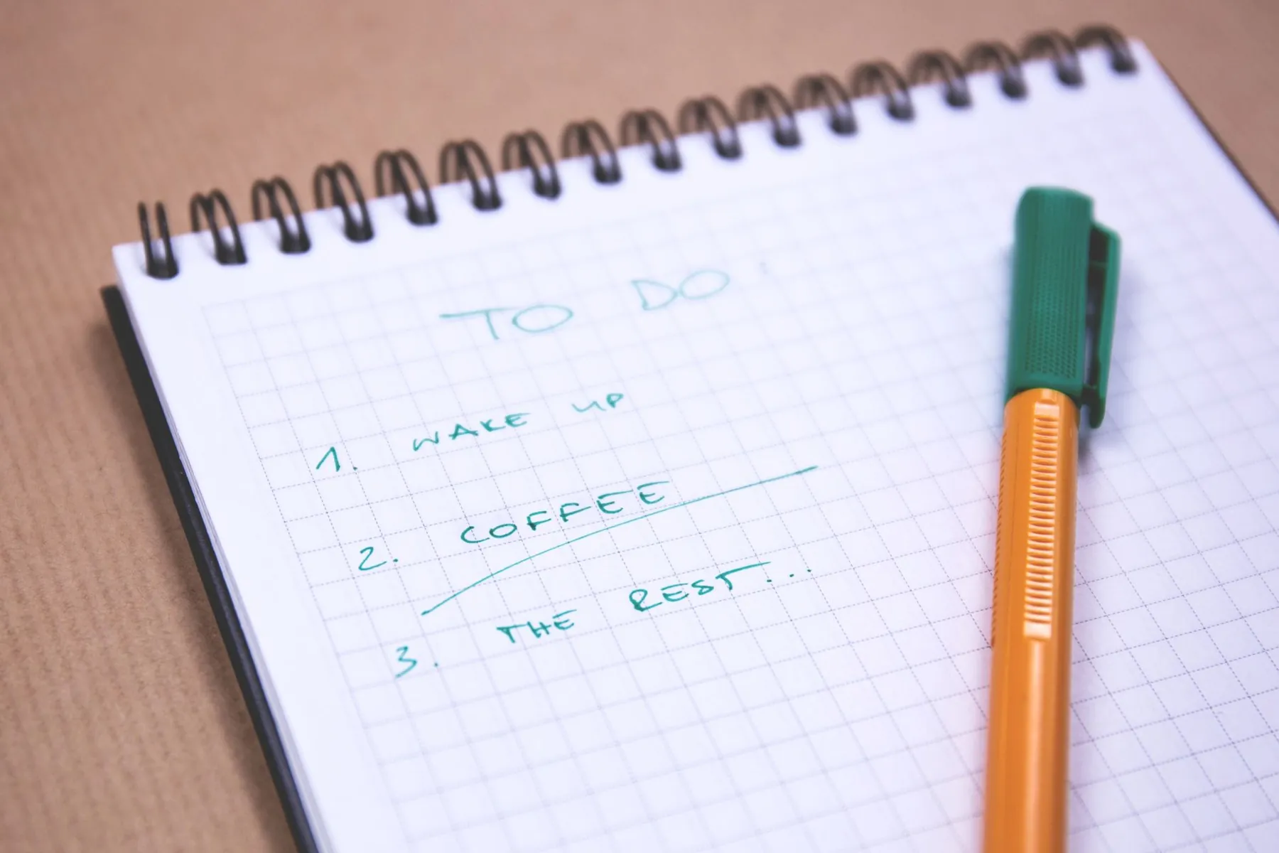 A notebook and pen on a desk, illustrating writing questions down before a consultation.