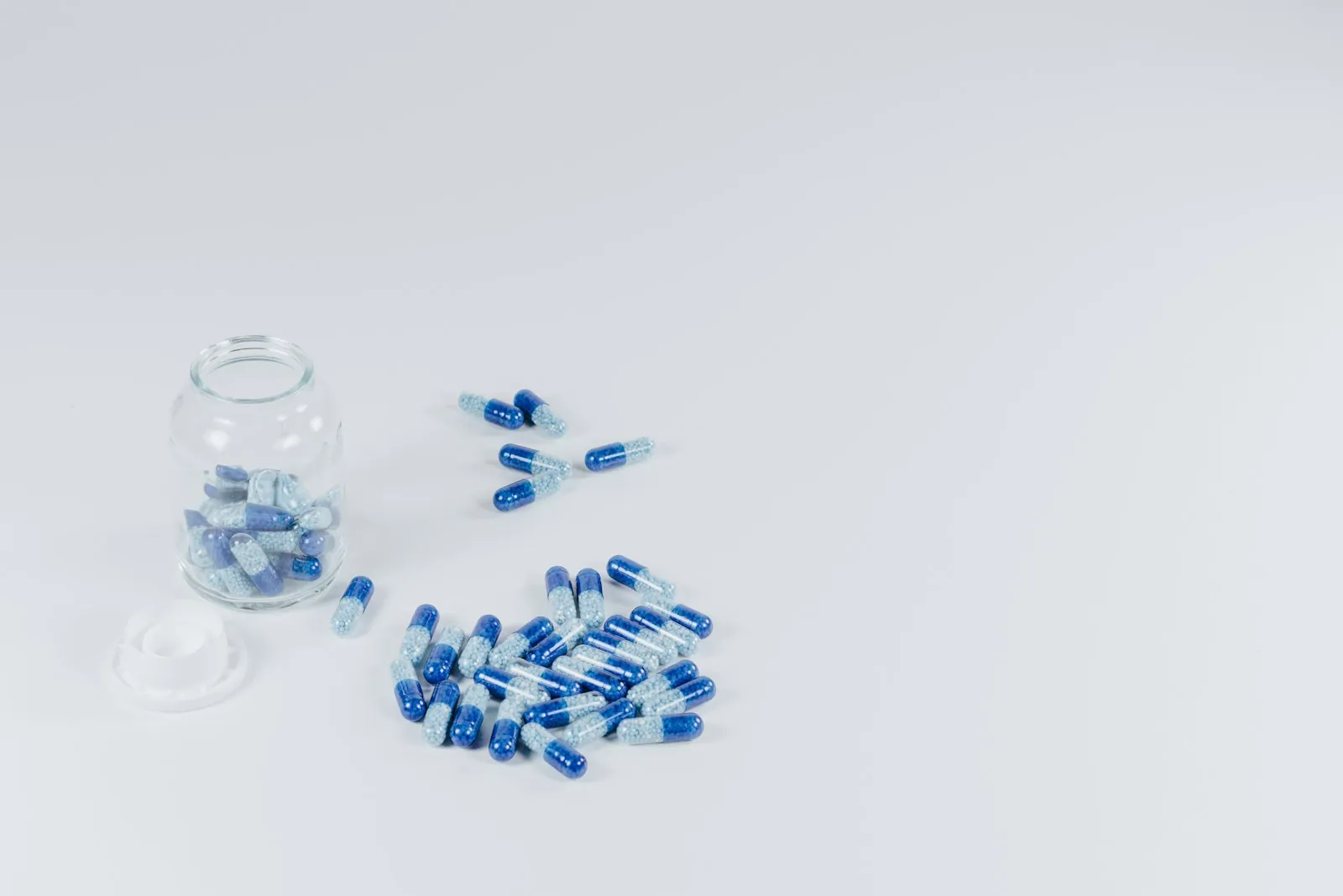 Medicines arranged on a plain surface, illustrating the medication list to bring to a consultation.
