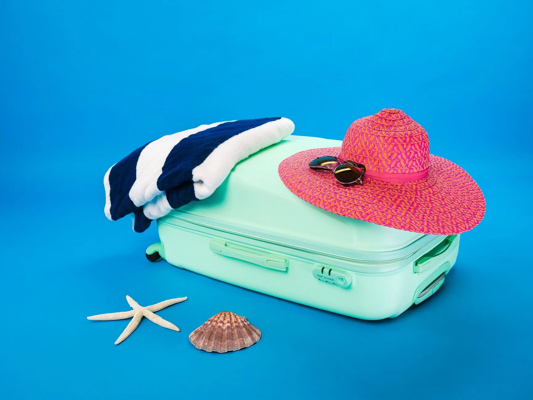 A hat and sunglasses ready to go, illustrating protecting the nose from sun.