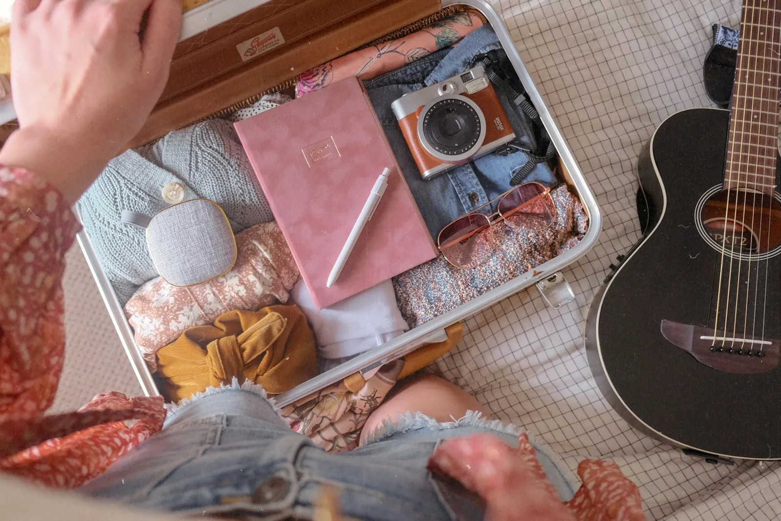 An open suitcase with neatly folded clothes, illustrating packing for surgery abroad.