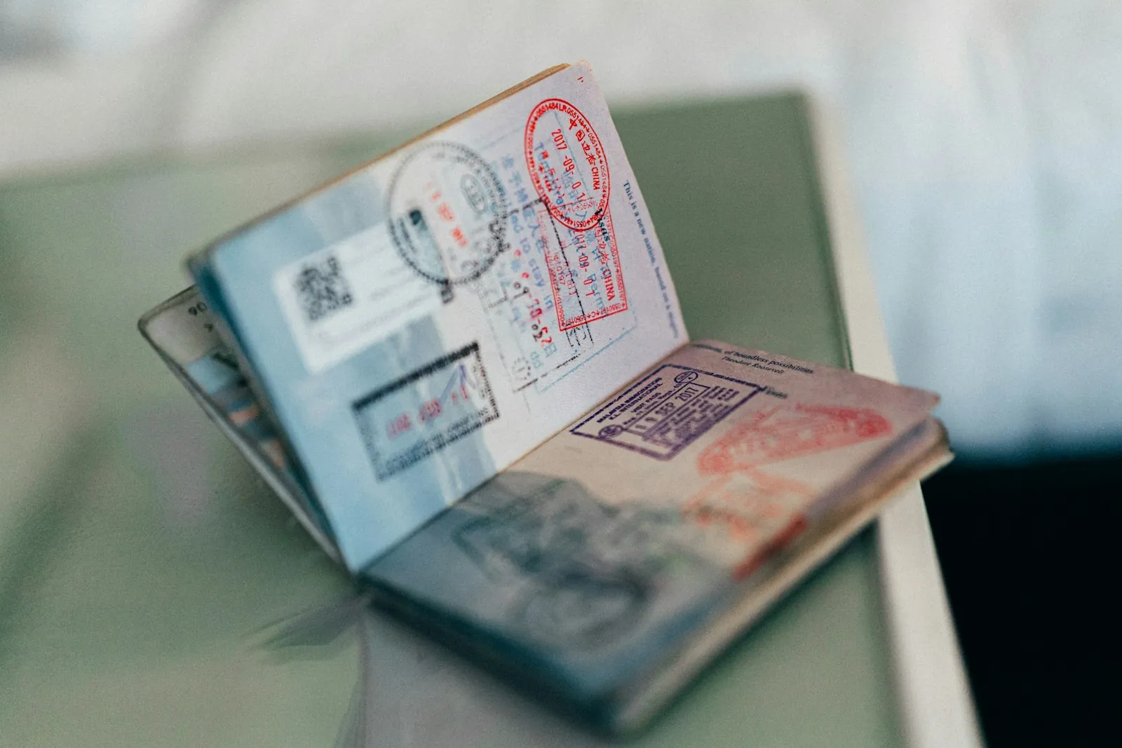 Travel documents and a folder on a desk, illustrating the paperwork to bring.