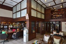 The clinic's reception and seating area, in timber and glass over two levels. The practice's own photograph.