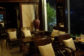 The waiting area at the clinic: timber and rattan armchairs with cream cushions. The practice's own photograph.