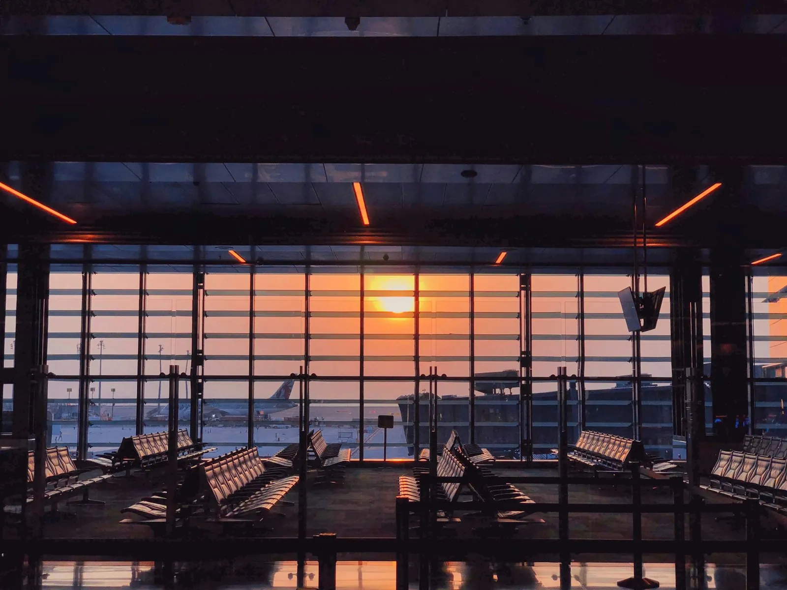 A quiet airport terminal window, illustrating information for patients travelling from abroad.
