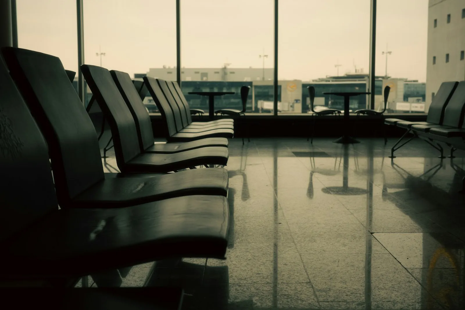 An empty airport departure lounge in warm morning light. An illustrative photograph accompanying information for patients travelling from abroad.