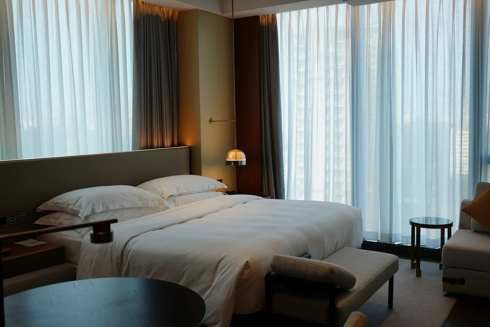 A quiet hotel room with daylight through the window, illustrating choosing somewhere restful to recover.