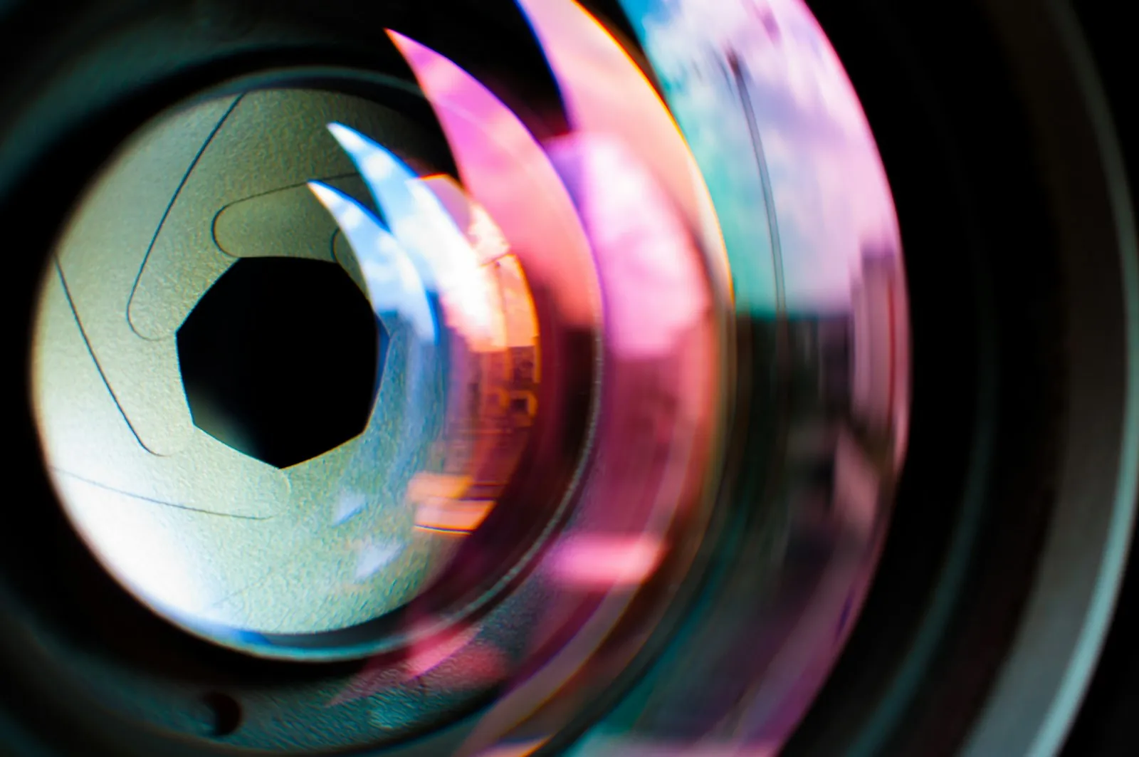 A camera lens, illustrating how lens choice and distance alter how photographs represent a face.