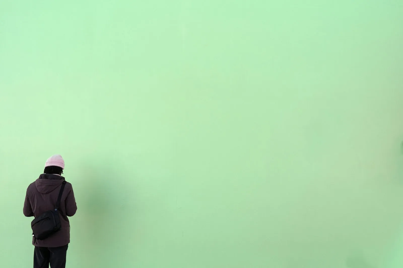 A camera set up against a plain wall, illustrating photographing your own progress.