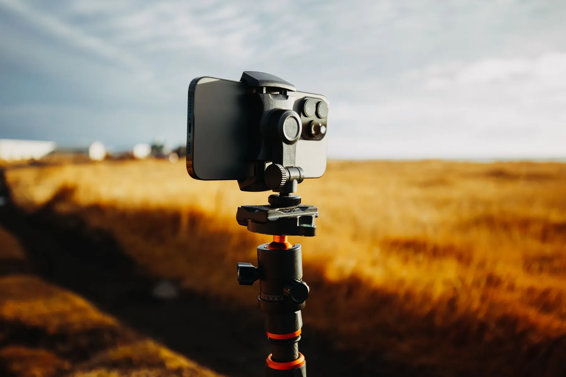 A camera set up against a plain wall, illustrating taking your own profile photographs.