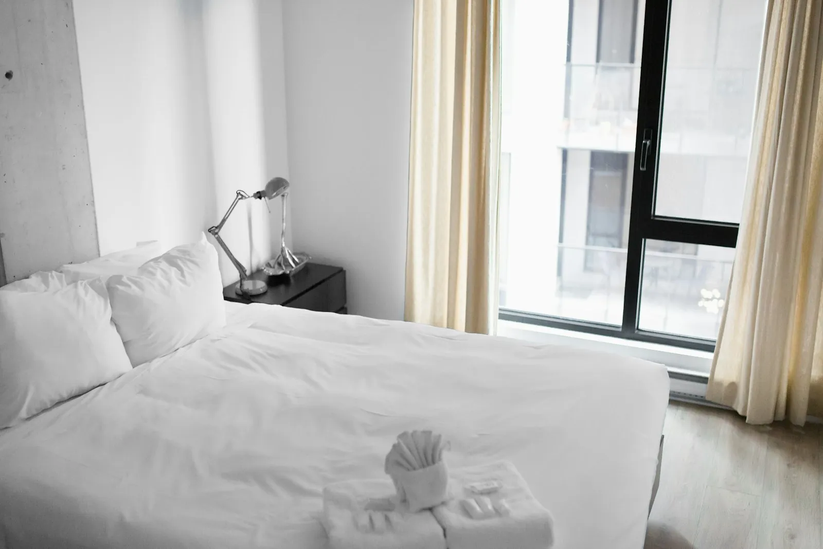 A quiet room with made bed and daylight through a window, illustrating rest during recovery.