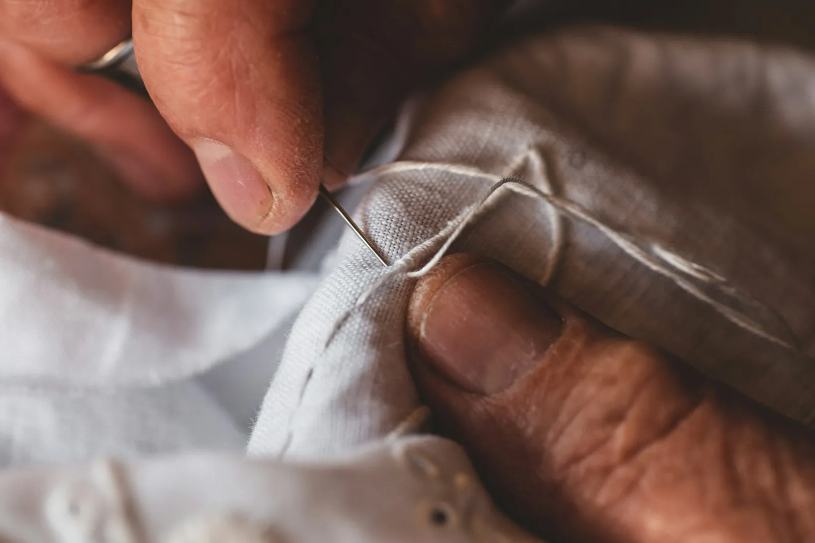 A seam being mended, illustrating refining a repair that has already been made.