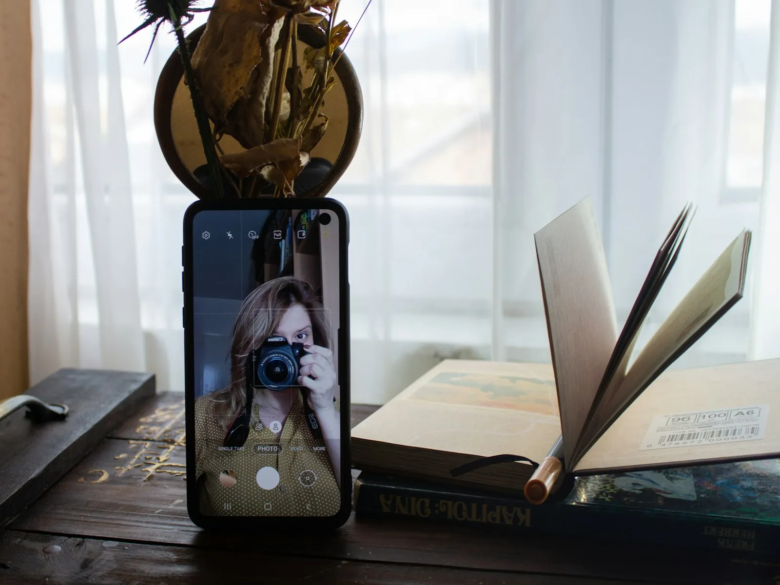 A phone set up in daylight, illustrating keeping a monthly photographic record.