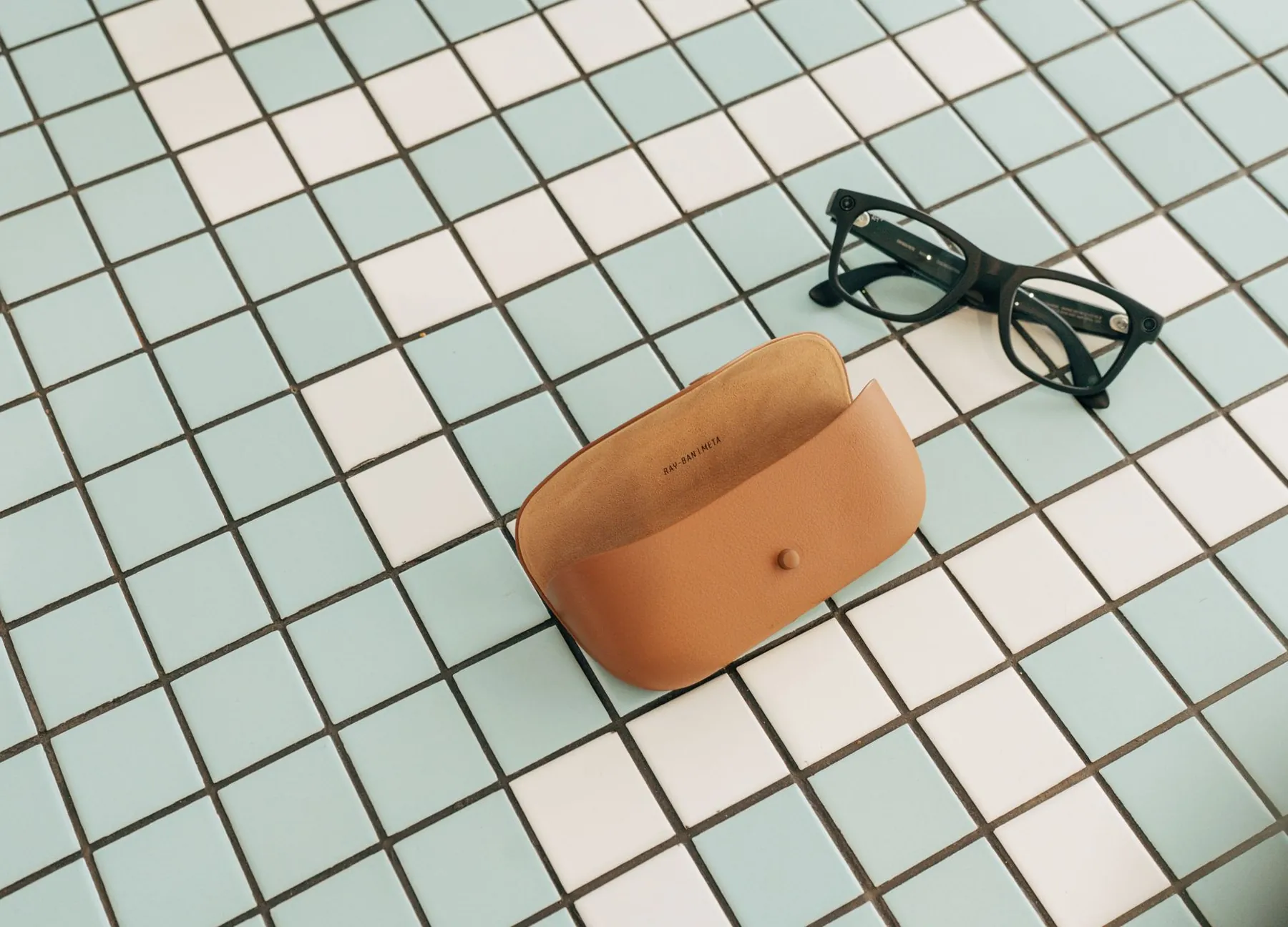 A spectacles case on a desk, illustrating wearing glasses rather than lenses.
